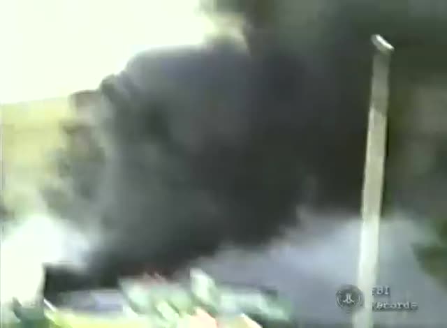 Poster frame from FBI Records Clip: A Building Ablaze and Crews at a Roadside Scene